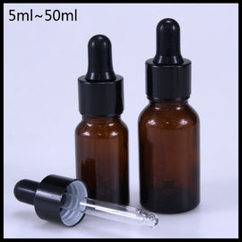 China Durable Amber Essential Oil Glass Bottles Black Aluminum Screw Cap Round Shape supplier